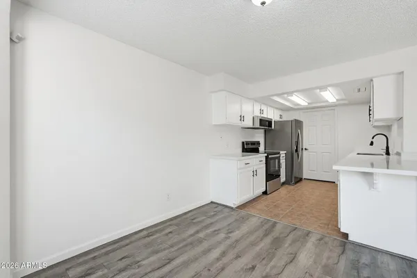 a kitchen with refrigerator and cabinets