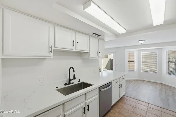 a kitchen with a sink cabinets and window