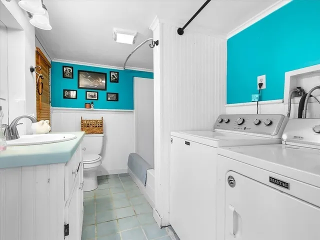 a bathroom with a sink toilet and mirror