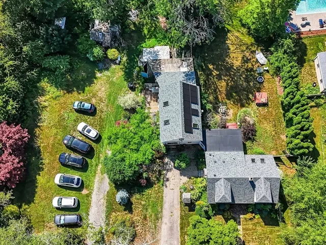 an aerial view of a house with swimming pool and garden