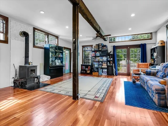a living room with lots of furniture and a wooden floor