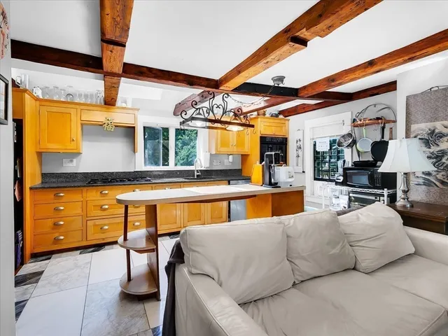 a living room with furniture and kitchen view