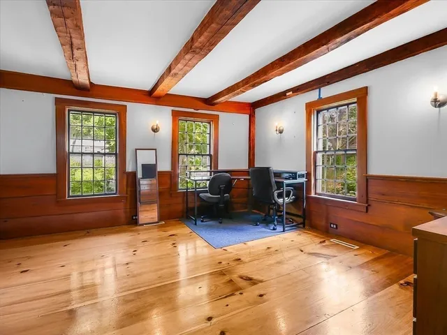 a living room with furniture large window and chair