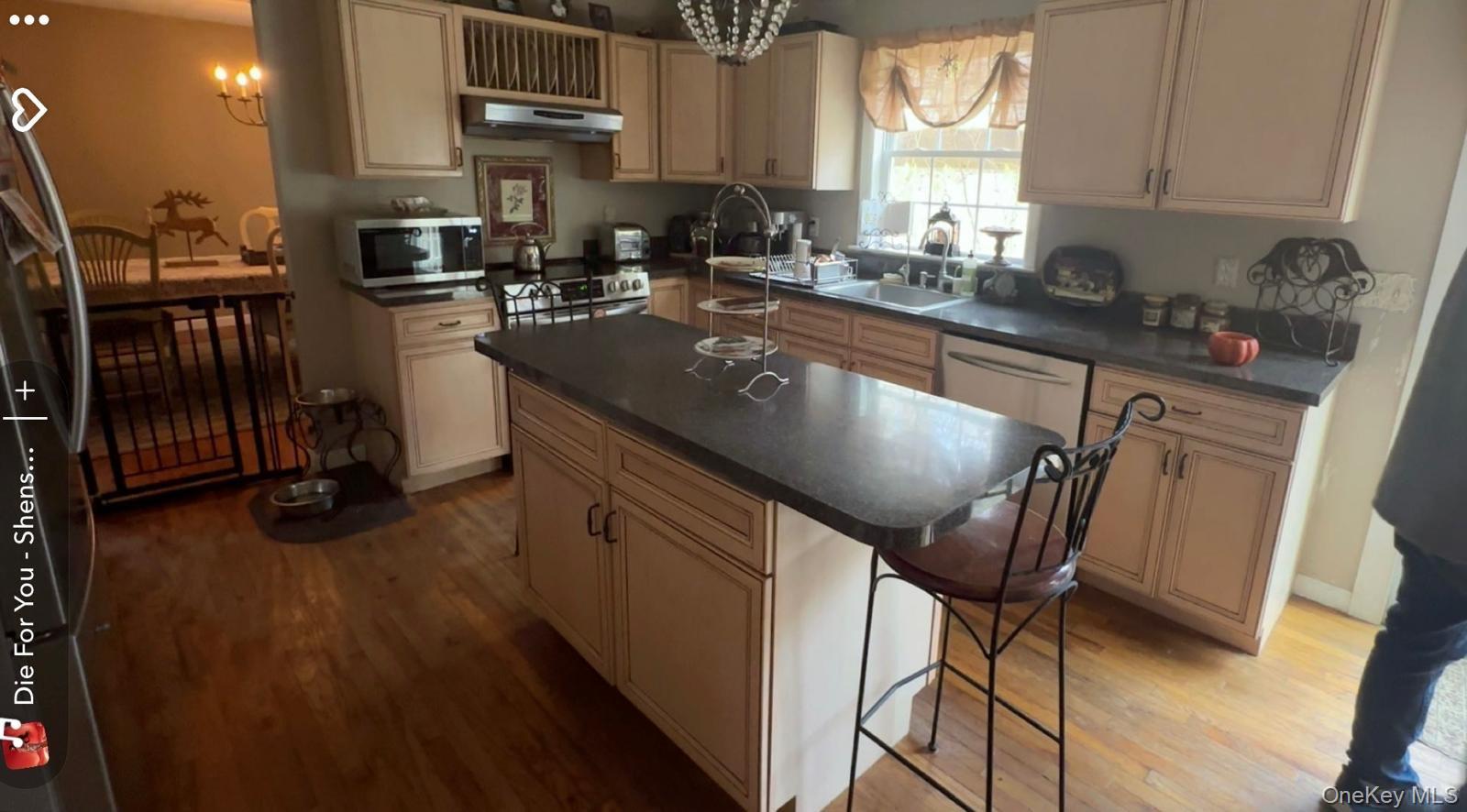 43 North Cozine Road Manorville, NY 11949 - Photo 13 of 42 Kitchen with a center island, stainless steel appliances, a chandelier, and dark wood finished floors
