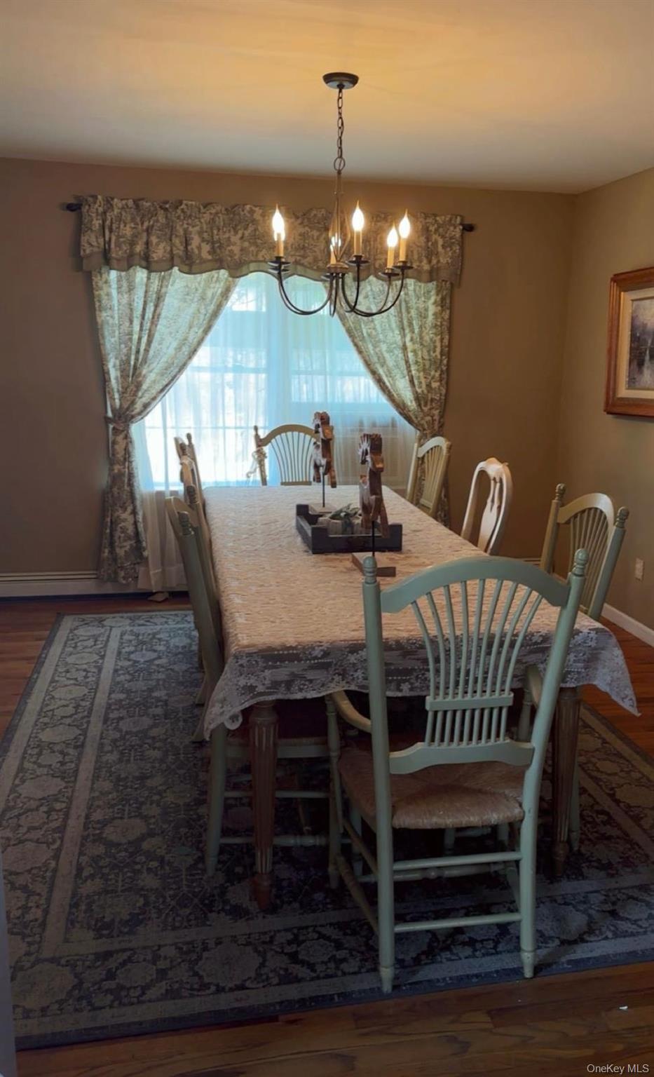 43 North Cozine Road Manorville, NY 11949 - Photo 15 of 42 Dining space with dark wood finished floors and a chandelier