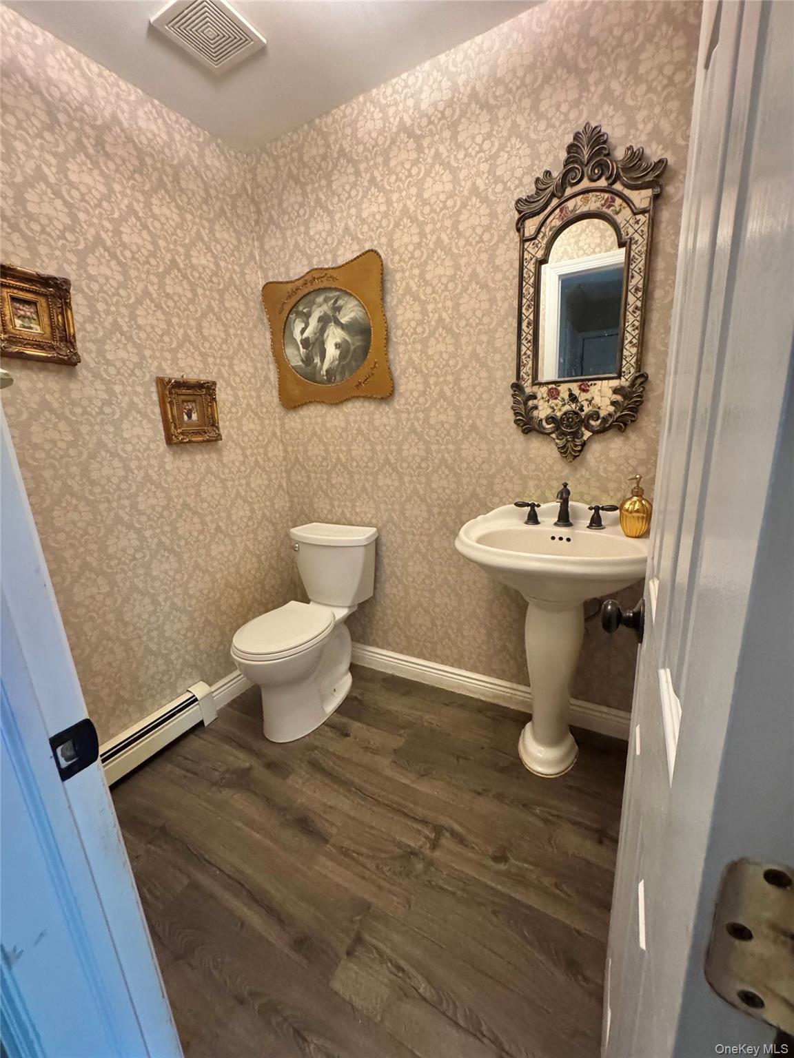 43 North Cozine Road Manorville, NY 11949 - Photo 17 of 42 Bathroom featuring baseboard heating and dark wood finished floors