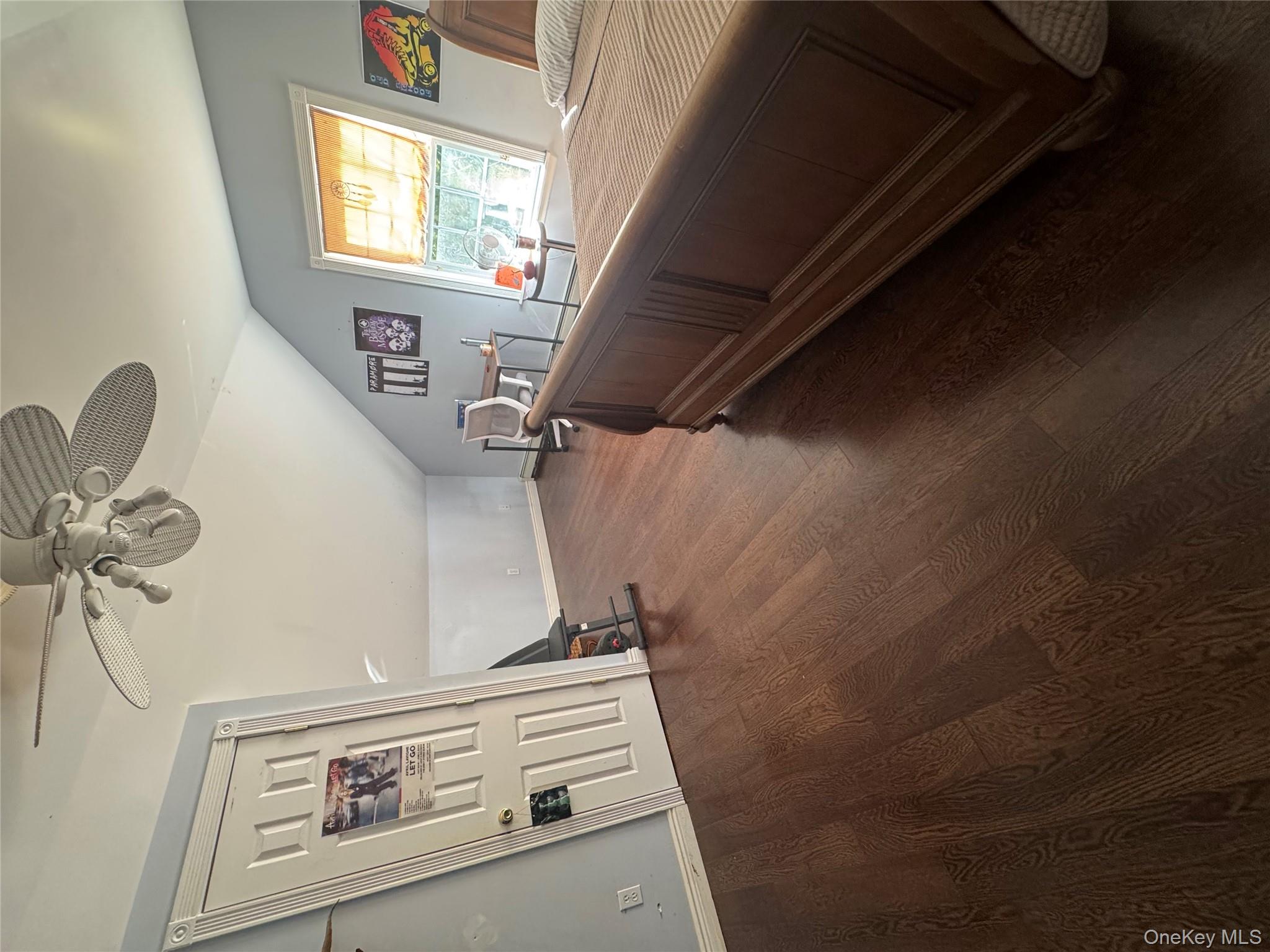 43 North Cozine Road Manorville, NY 11949 - Photo 21 of 42 Bedroom featuring lofted ceiling, dark wood-style floors, and a ceiling fan