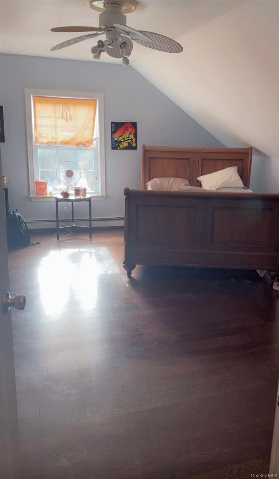 43 North Cozine Road Manorville, NY 11949 - Photo 23 of 42 Bedroom featuring ceiling fan, vaulted ceiling, wood finished floors, and a baseboard heating unit