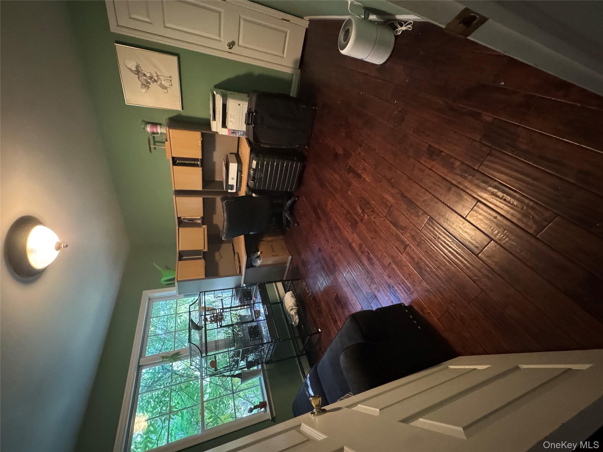 43 North Cozine Road Manorville, NY 11949 - Photo 26 of 42 Office area with dark wood-style floors and a baseboard radiator