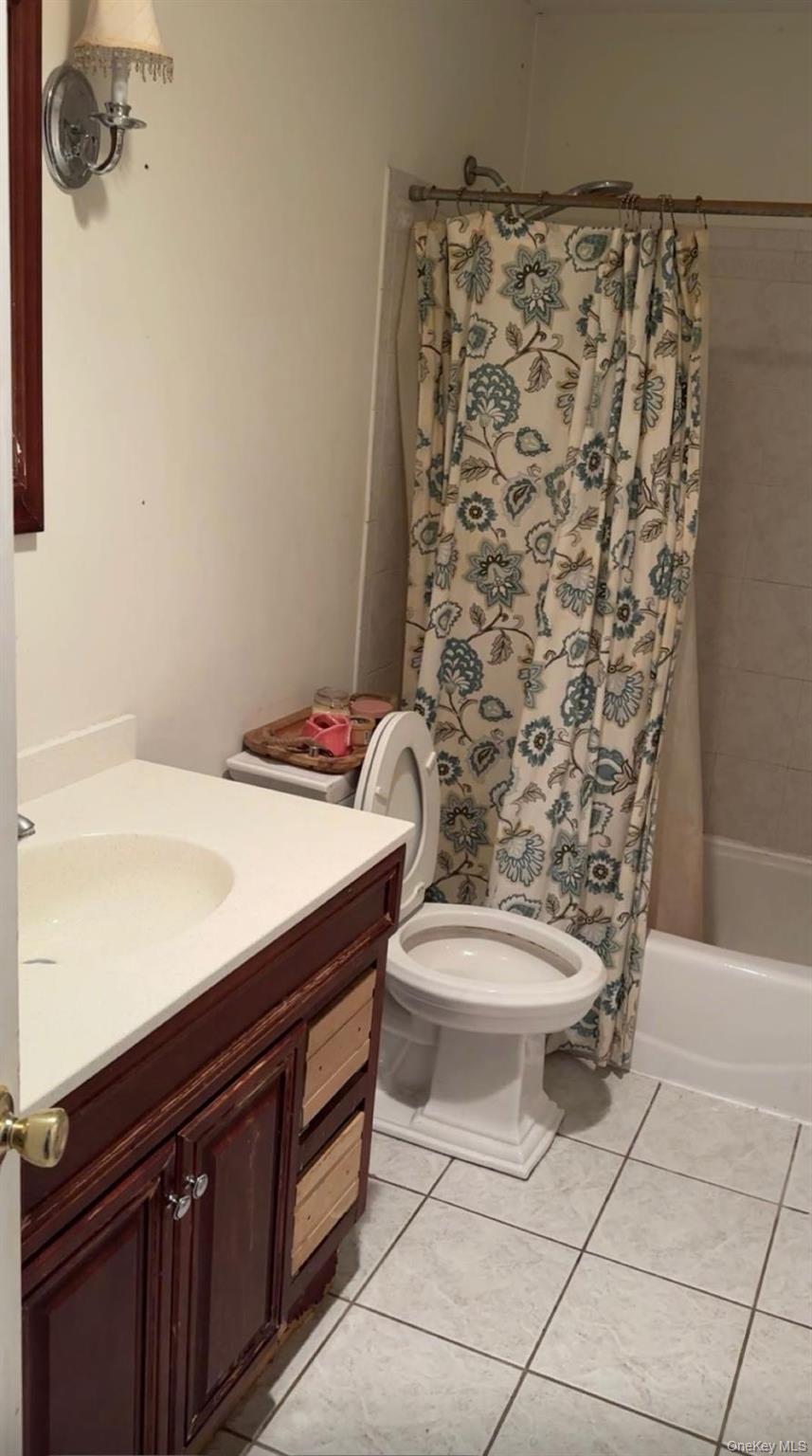 43 North Cozine Road Manorville, NY 11949 - Photo 28 of 42 Full bath featuring shower / tub combo, vanity, and light tile patterned floors