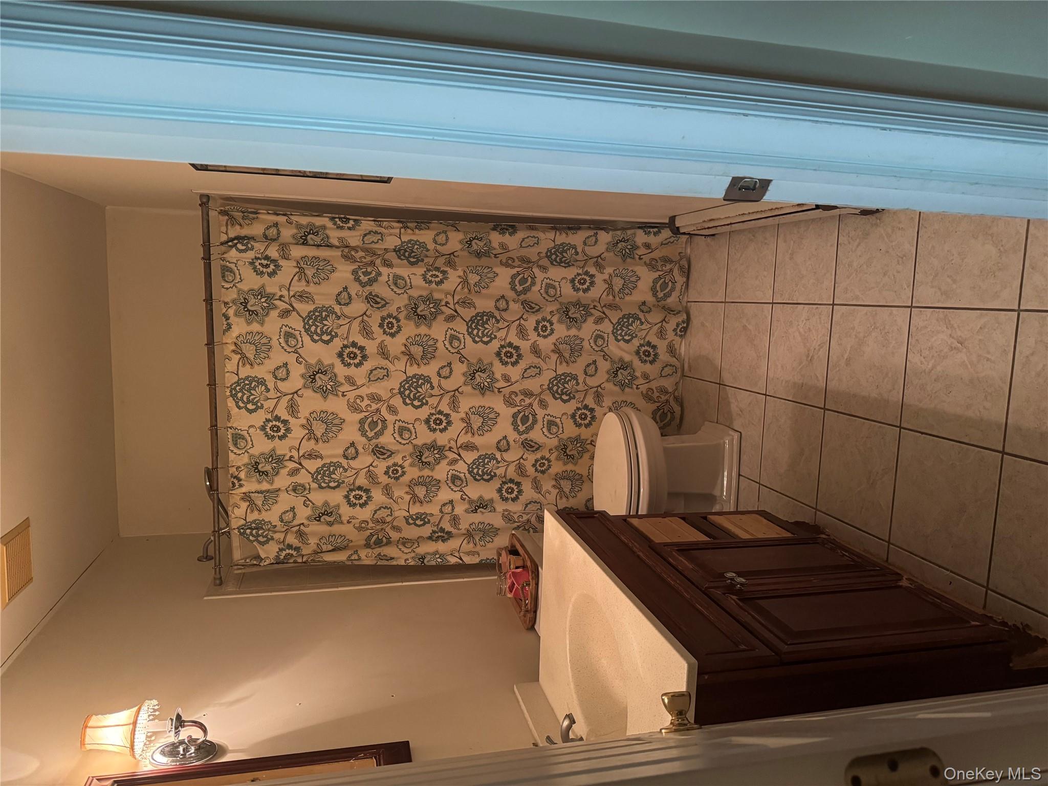 43 North Cozine Road Manorville, NY 11949 - Photo 29 of 42 Full bathroom with light tile patterned floors, vanity, and a shower with shower curtain