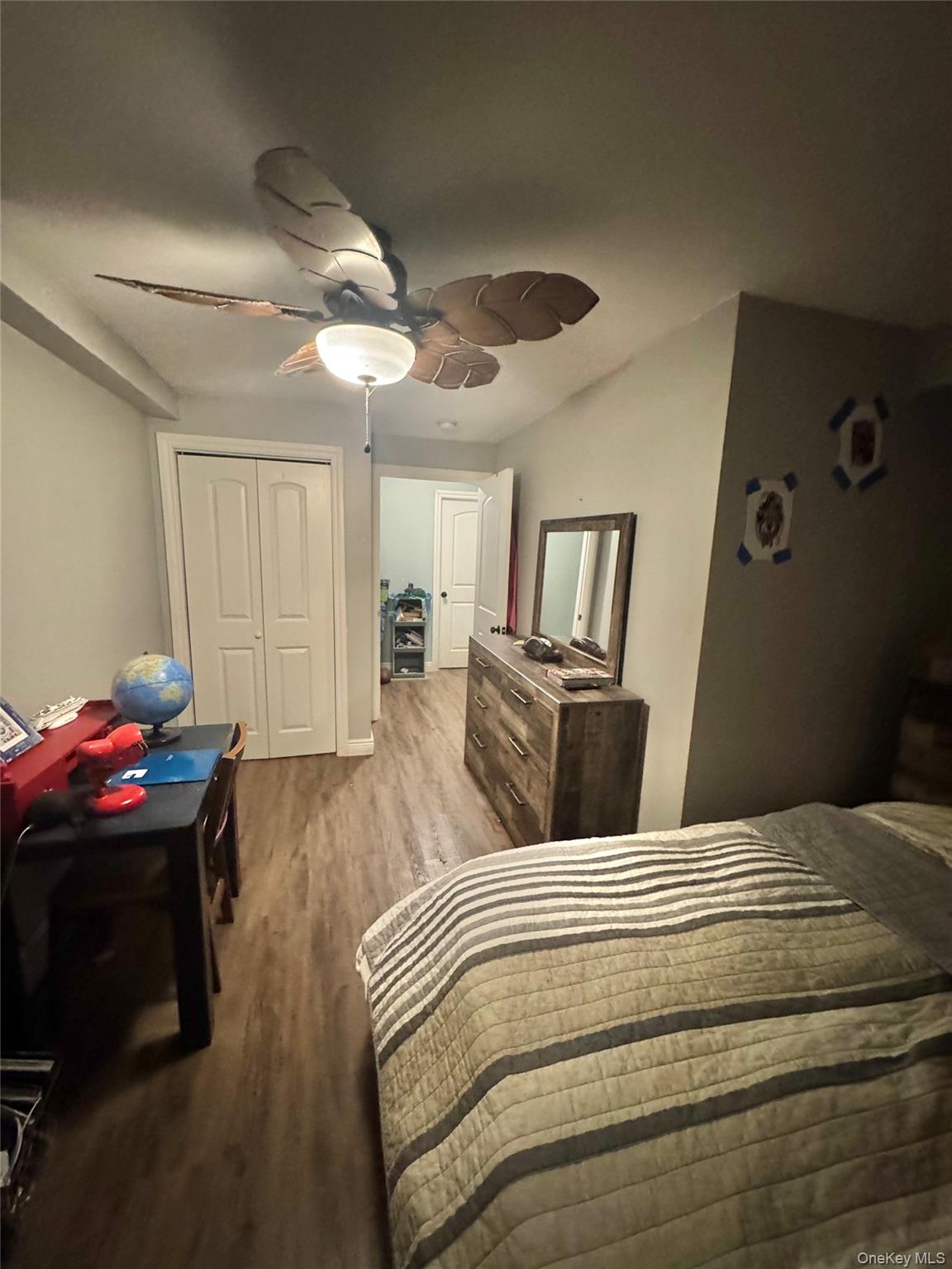 43 North Cozine Road Manorville, NY 11949 - Photo 34 of 42 Bedroom featuring a closet, ceiling fan, and wood finished floors