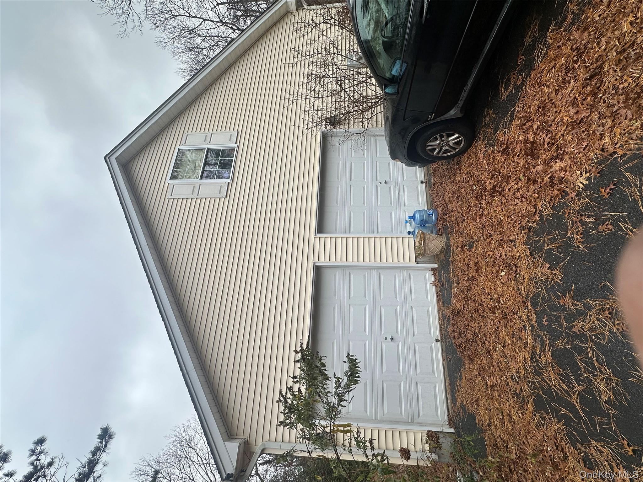 43 North Cozine Road Manorville, NY 11949 - Photo 37 of 42 View of home's exterior with a garage