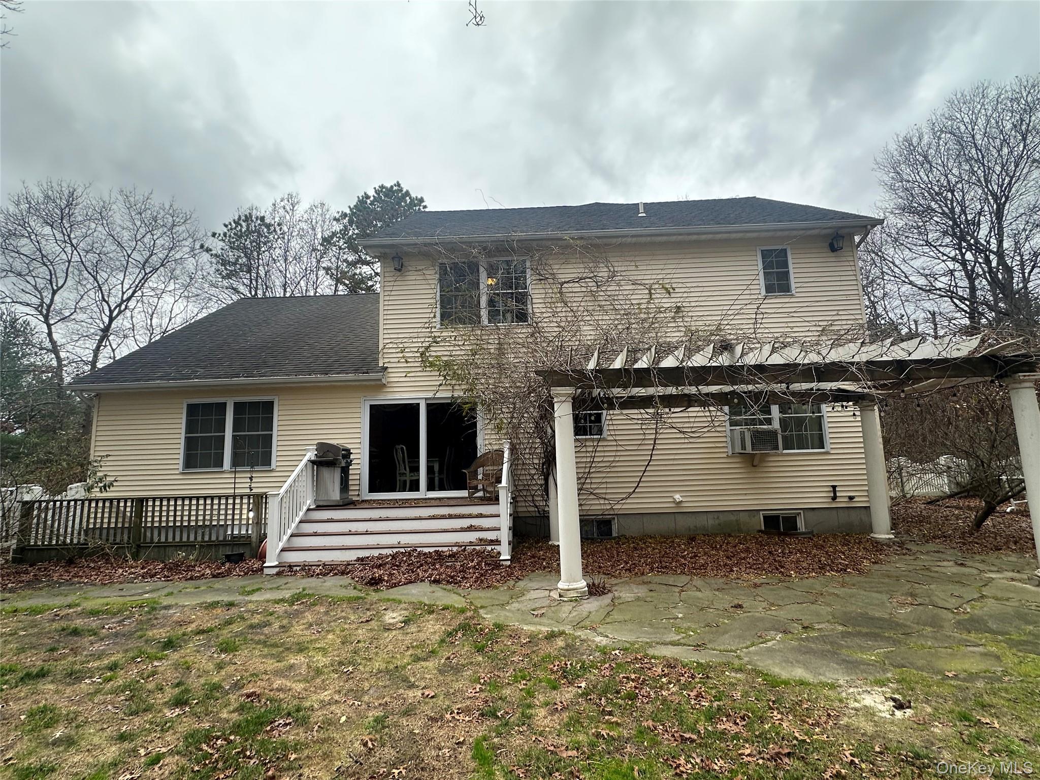 43 North Cozine Road Manorville, NY 11949 - Photo 38 of 42 Rear view of property featuring a patio, a wooden deck, roof with shingles, a yard, and a pergola