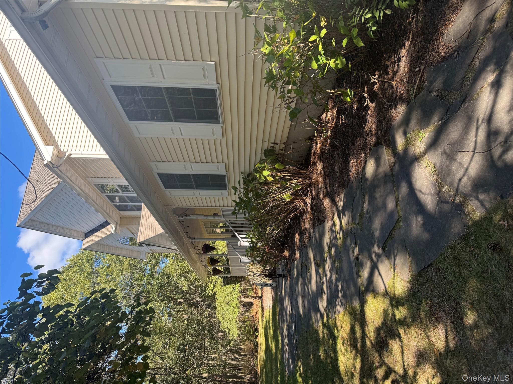 43 North Cozine Road Manorville, NY 11949 - Photo 4 of 42 View of home's exterior with a porch