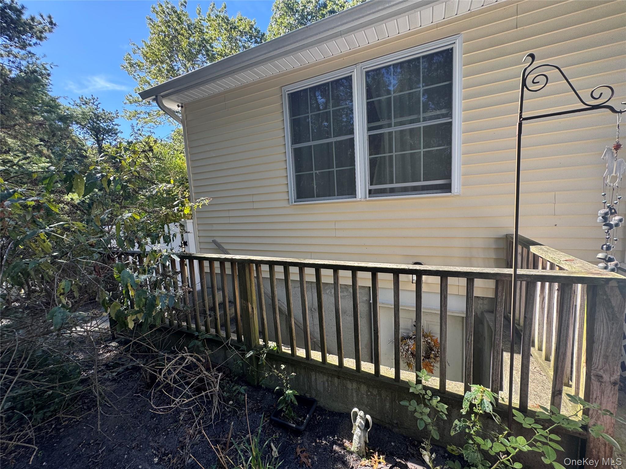 43 North Cozine Road Manorville, NY 11949 - Photo 6 of 42 View of property exterior featuring a wooden deck