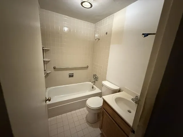 a bathroom with a toilet a sink and bathtub