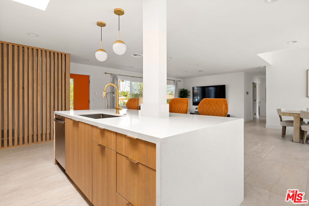 74085 Setting Sun Trail Palm Desert, CA 92260 - Photo 15 of 52 a kitchen with a sink a counter and chairs