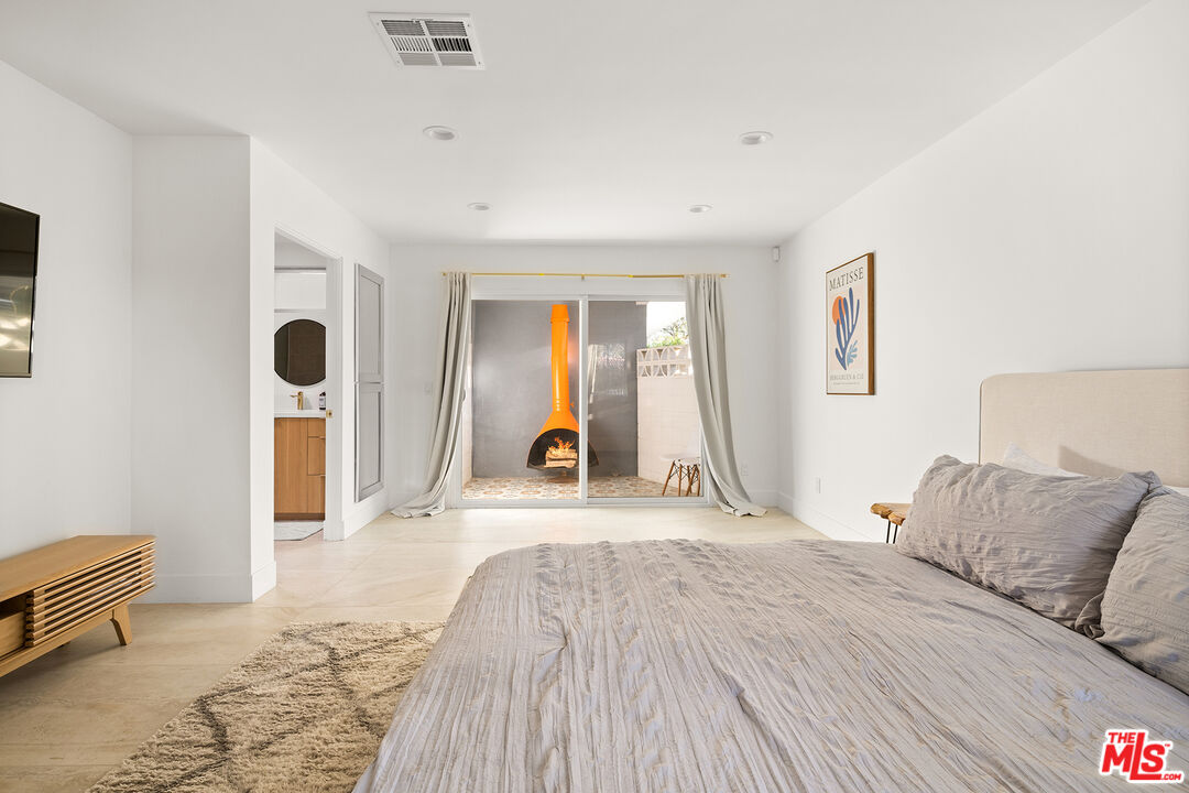 74085 Setting Sun Trail Palm Desert, CA 92260 - Photo 19 of 52 a bedroom with a bed and a large window