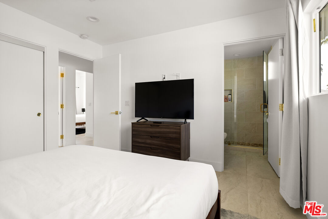 74085 Setting Sun Trail Palm Desert, CA 92260 - Photo 27 of 52 a bedroom with a bed and a flat screen tv