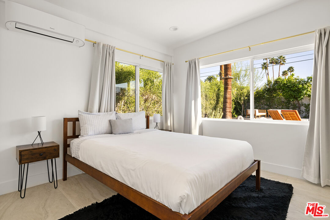 74085 Setting Sun Trail Palm Desert, CA 92260 - Photo 28 of 52 a bedroom with a bed and a window