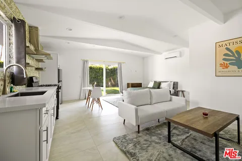 a kitchen with a table chairs and a refrigerator