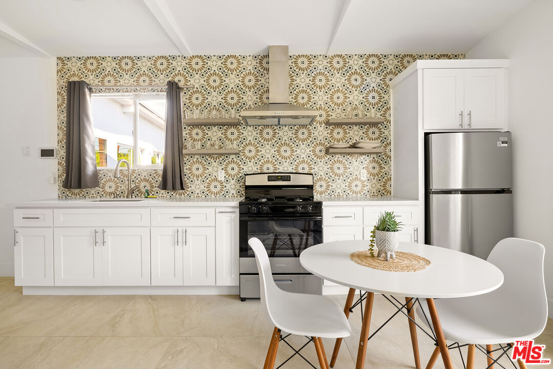 74085 Setting Sun Trail Palm Desert, CA 92260 - Photo 40 of 52 a kitchen with a table chairs and a refrigerator