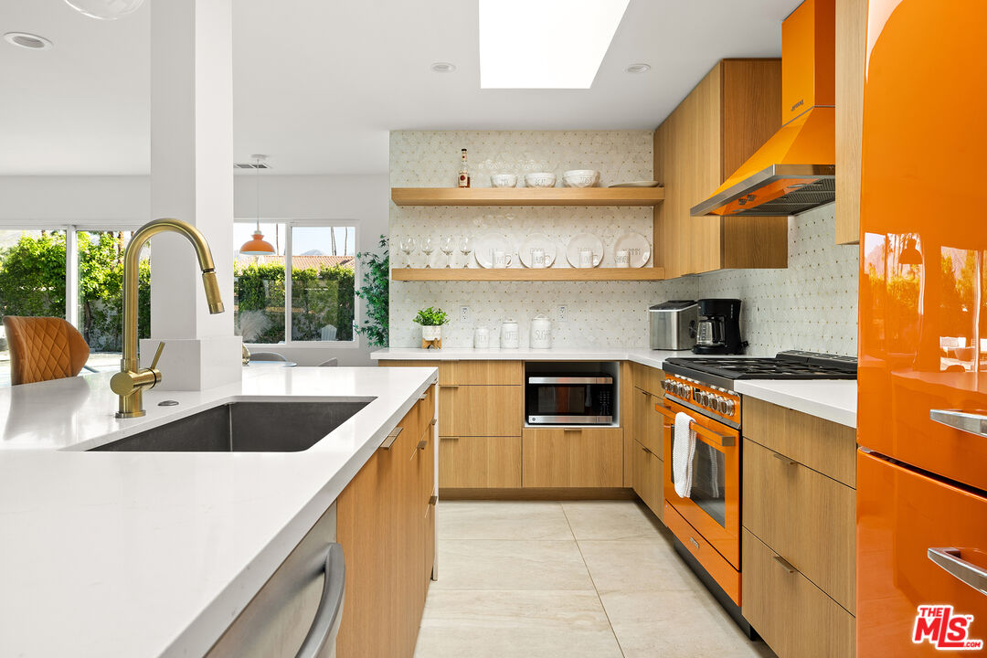 74085 Setting Sun Trail Palm Desert, CA 92260 - Photo 5 of 52 a kitchen with stainless steel appliances granite countertop a sink and a stove