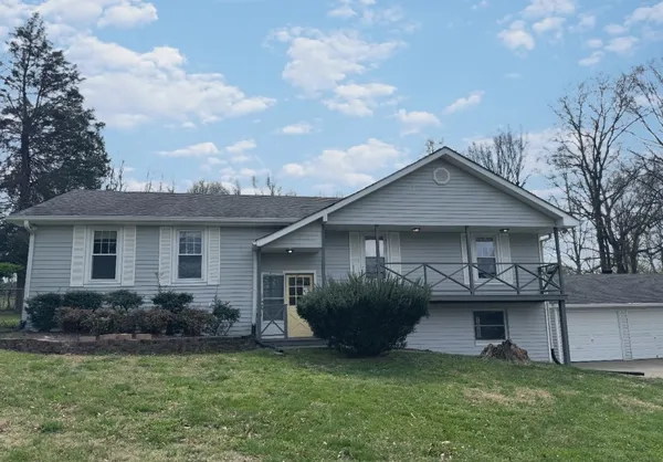 a front view of a house with a garden and plants
