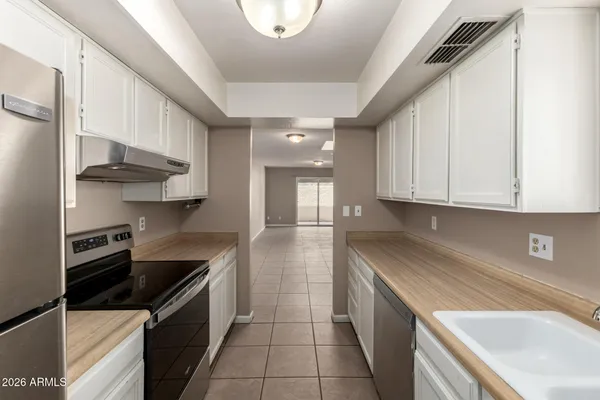 a kitchen with stainless steel appliances a sink stove and cabinets