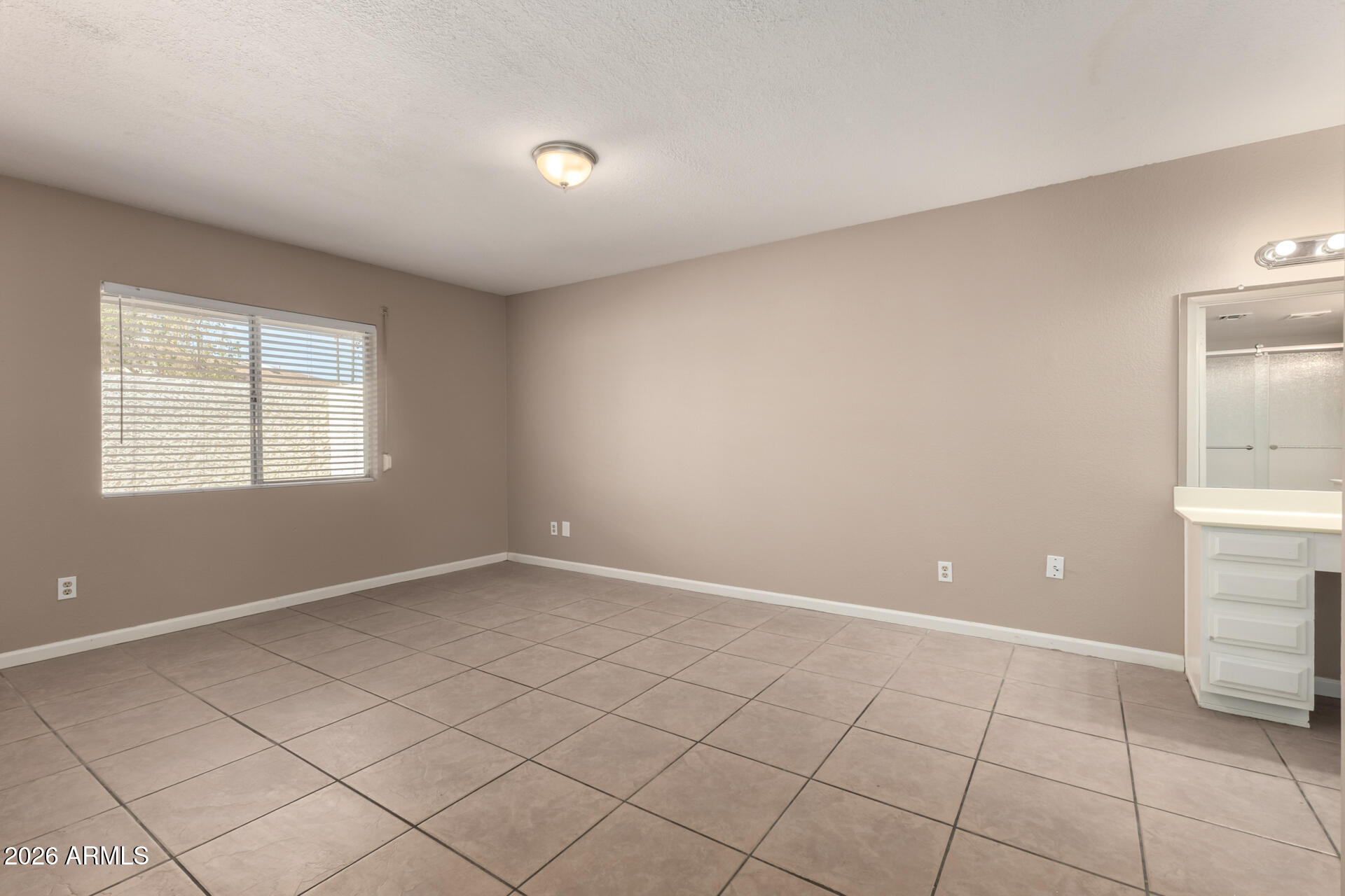 4529 West McLellan Road Glendale, AZ 85301 - Photo 17 of 35 a view of an empty room with window and cabinet