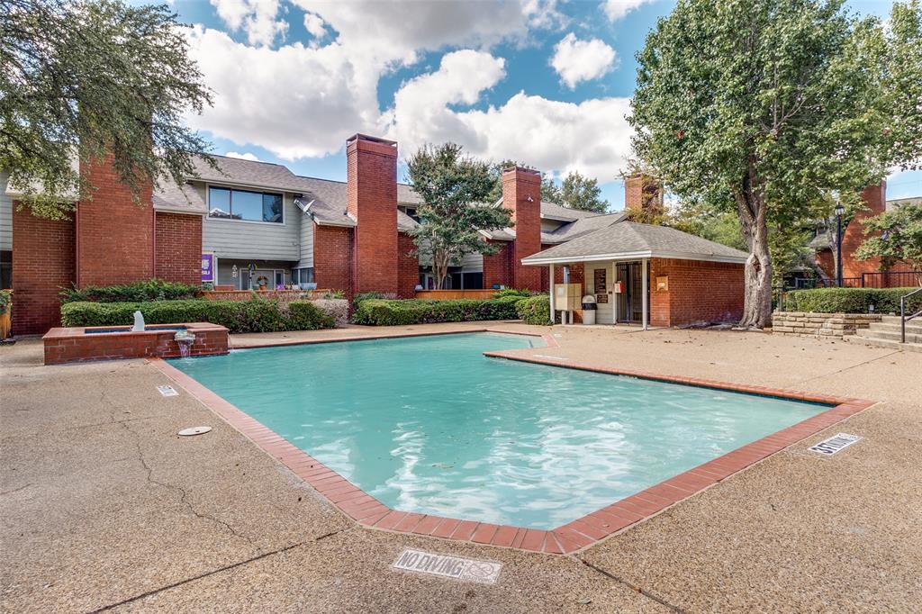 8404 Forest Lane, Unit 702 Dallas, TX 75243 - Photo 12 of 12 a view of a yard in front of a brick house