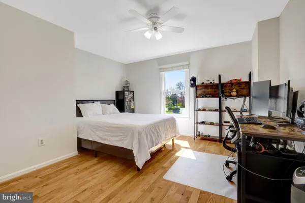 a bedroom with a bed and a desk