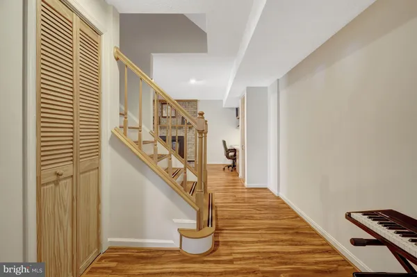 a view of entryway and hall with wooden floor