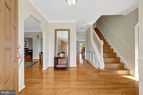 a view of a hallway view with wooden floor and staircase