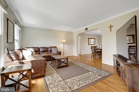 a living room with furniture a rug and a table