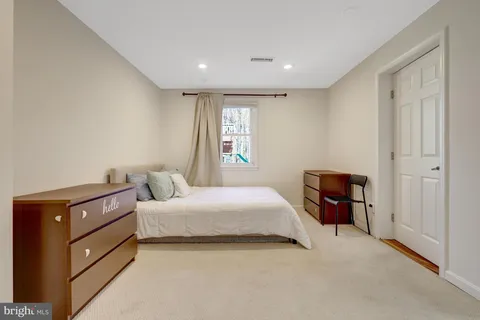 a bedroom with a bed and dresser