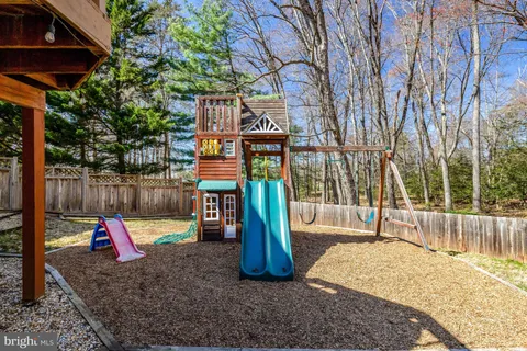 a view of outdoor space with playground and green space