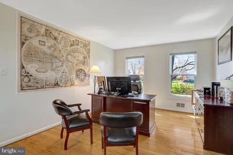 a view of a workspace with furniture and a window