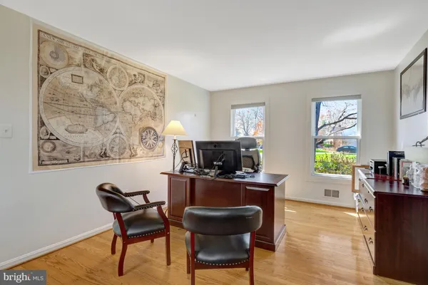 a view of a workspace with furniture and a window