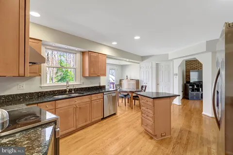a large kitchen with lots of counter top space and stainless steel appliances