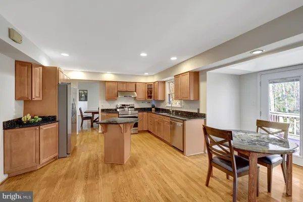 a kitchen with a table and chairs in it