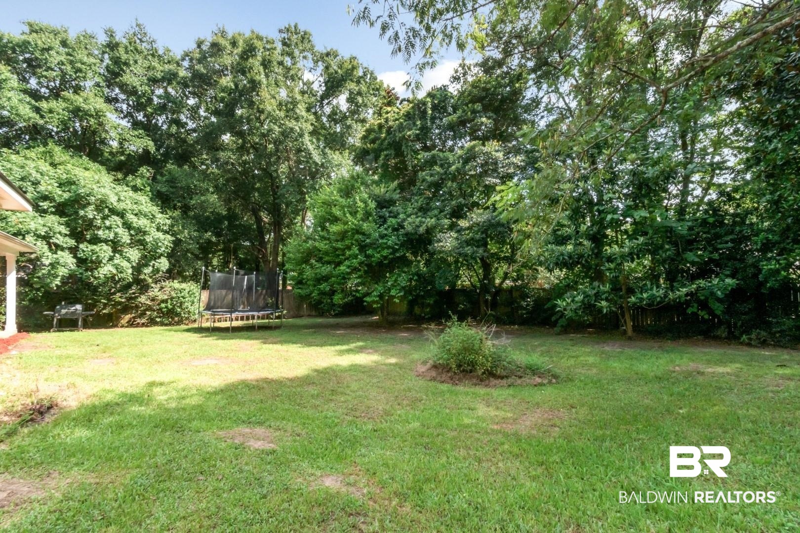 9991 Wedgefield Court Mobile, AL 36608 - Photo 28 of 30 View of yard featuring a trampoline