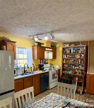 a kitchen with stainless steel appliances a stove a sink and a refrigerator