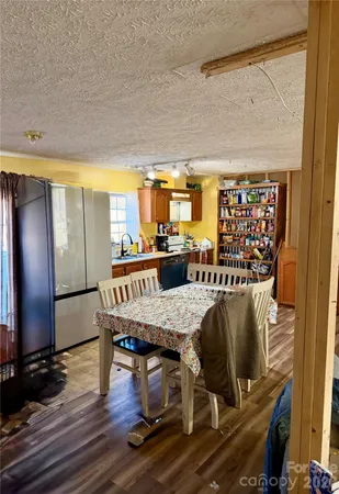 a dining room with furniture and wooden floor