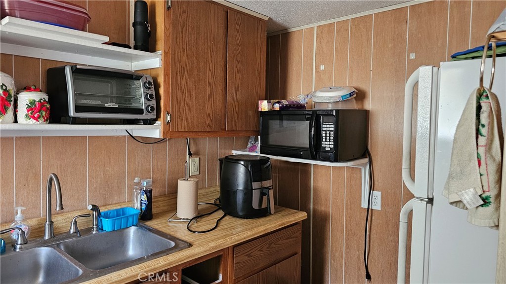 16067 Dam Road Clearlake, CA 95422 - Photo 14 of 30 a kitchen with stainless steel appliances a stove microwave and refrigerator