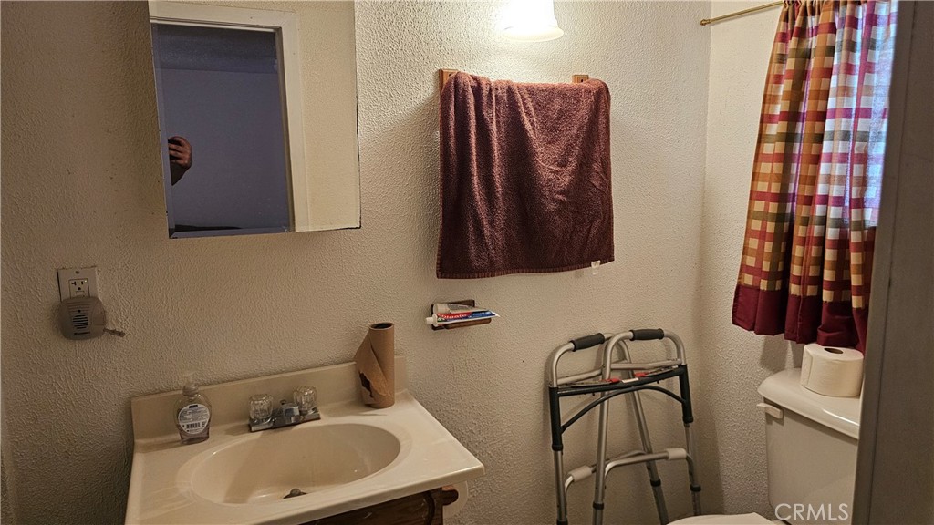 16067 Dam Road Clearlake, CA 95422 - Photo 16 of 30 a bathroom with a sink and mirror