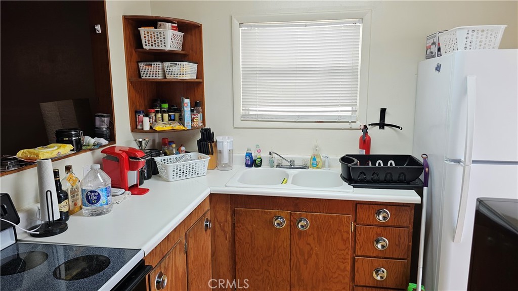 16067 Dam Road Clearlake, CA 95422 - Photo 21 of 30 a kitchen with a stove a refrigerator and a sink