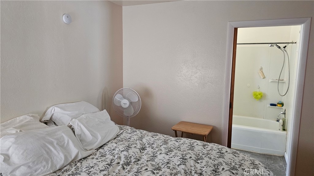 16067 Dam Road Clearlake, CA 95422 - Photo 26 of 30 a bedroom with a bed and a rug