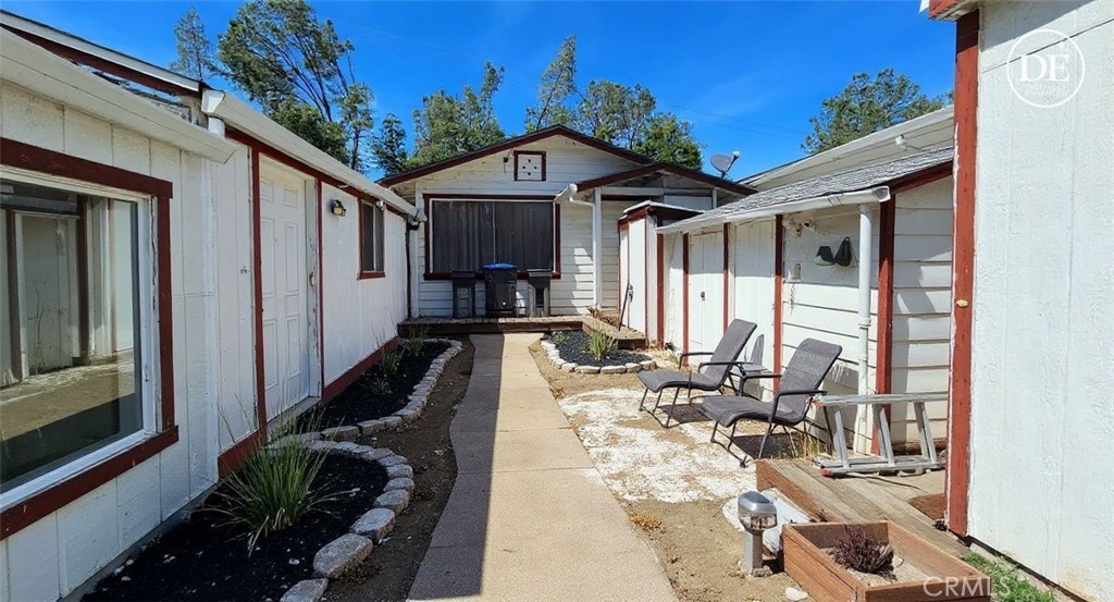 16067 Dam Road Clearlake, CA 95422 - Photo 10 of 30 a view of a patio with couches table and chairs with wooden floor and fence